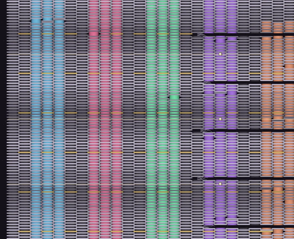A close-up of a woven textile: coloured warp threads crossing grey weft rows